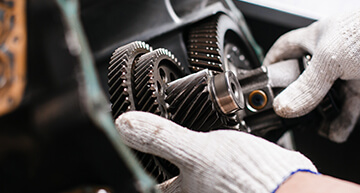Mechanic taking apart an automotive transmission