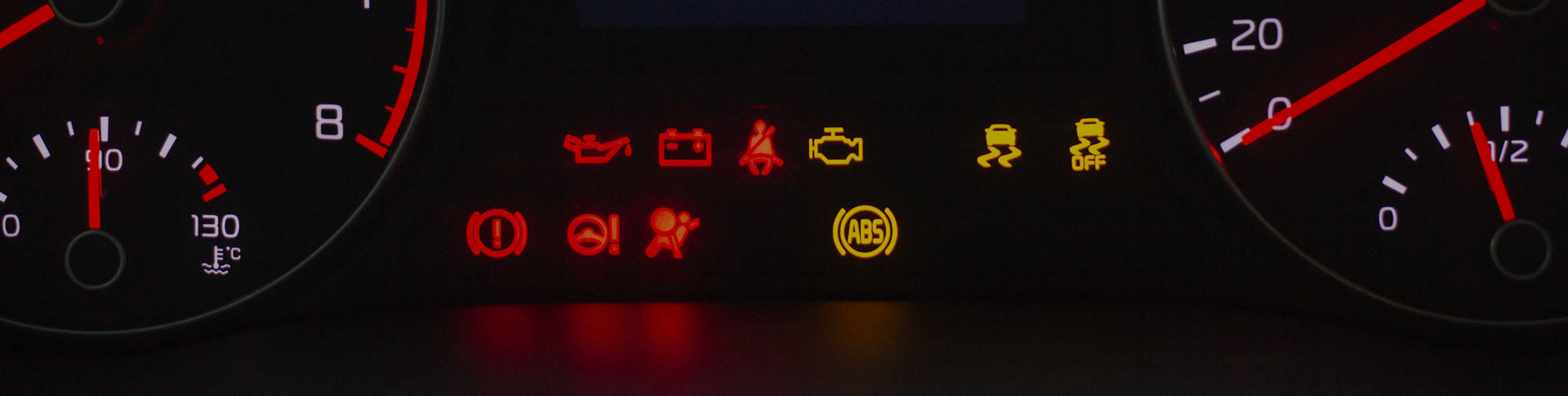 Auto dashboard with numerous lights and check engine alerts eluminated
